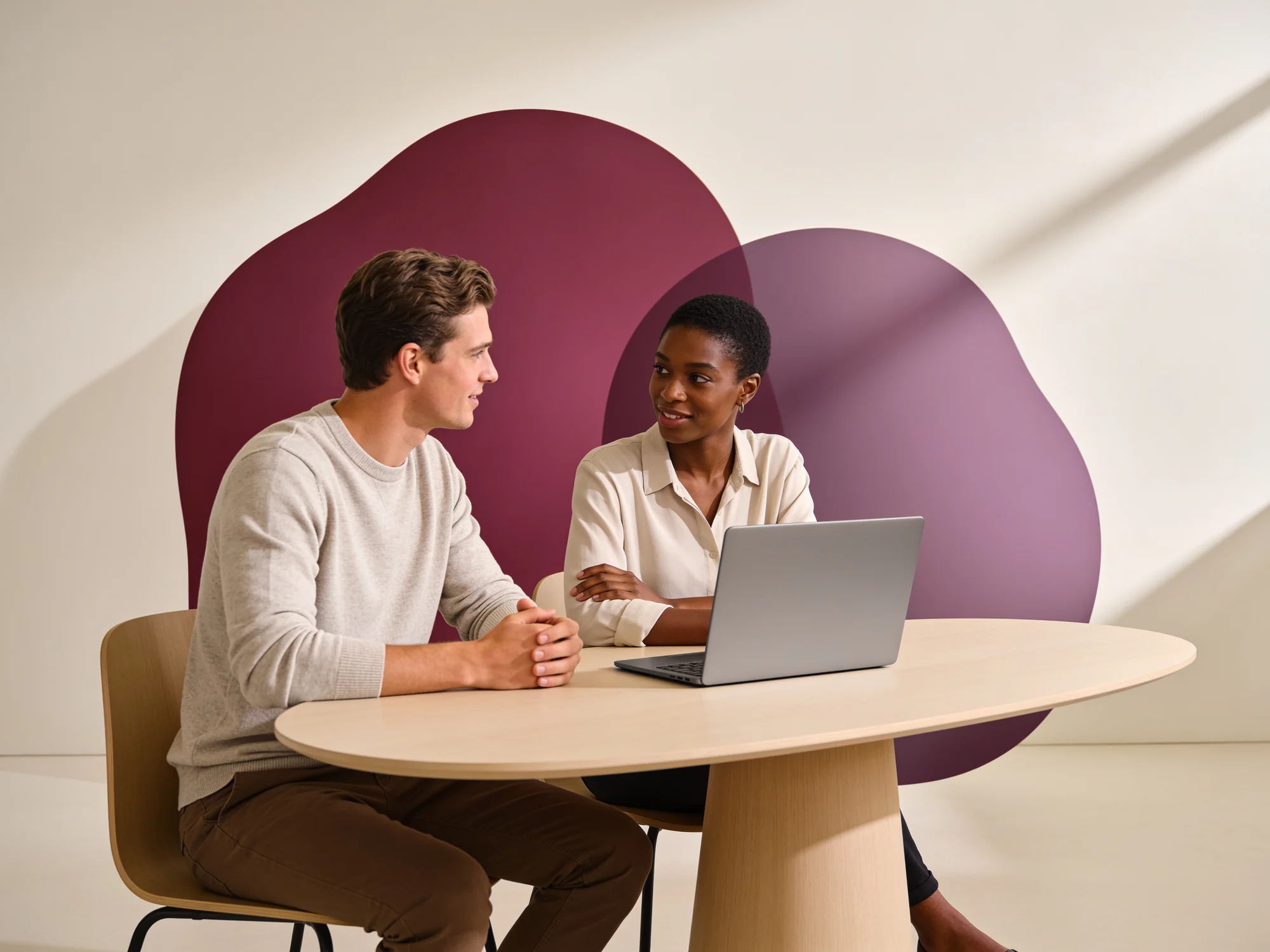 A Willsec engineer and a partner sitting at one table, working through a bid together on a single laptop.
